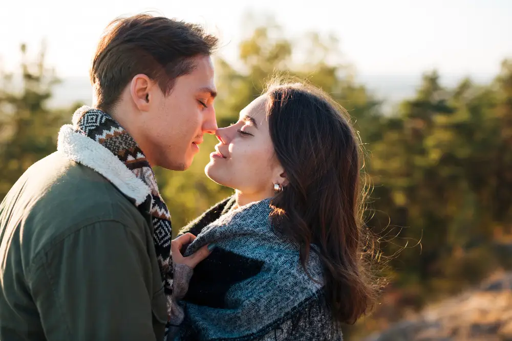 Boyfriend and girlfriend close together, sharing an intimate moment
