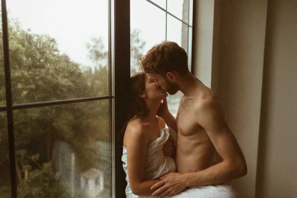 Couple sharing a slow deeply connected kiss with full presence and emotional intimacy