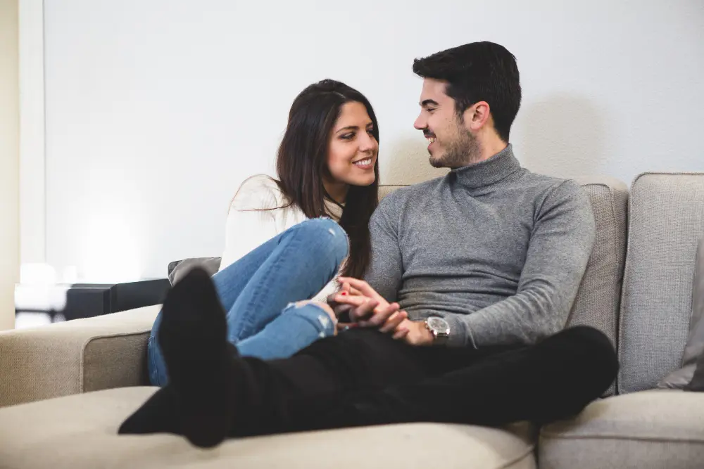 Man and woman spending relaxed time together indoors, comfortable and close