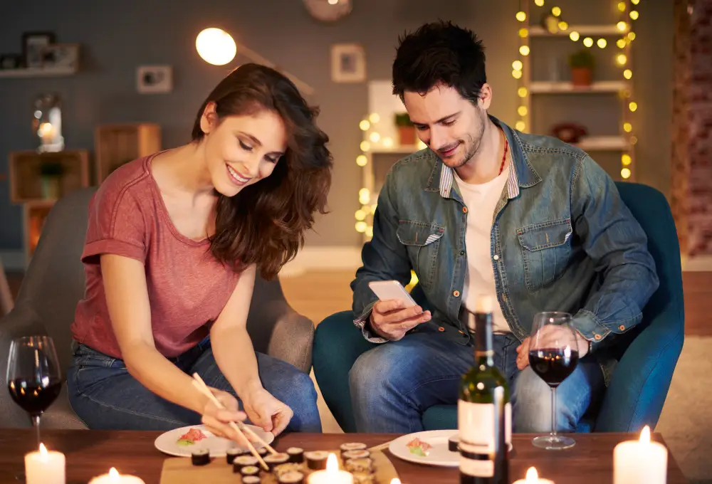 Couple smiling and enjoying dinner after meeting through an adult dating platform in 2026